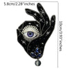 A black hand design featuring a large eye and blue gemstone pendant, suitable for clothing or craft projects.