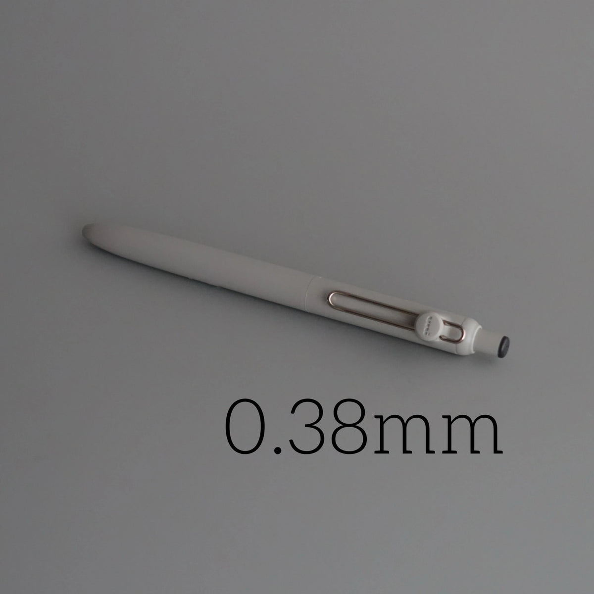 A close-up view of a white Uni ZENTO Quick-Dry Gel Pen, showing its slender body and tip.