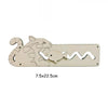 A light wood Montessori wooden busy board featuring a carved silhouette of a wolf and a fish.