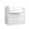A stack of white disposable bed sheets for salons, spas, and travel.