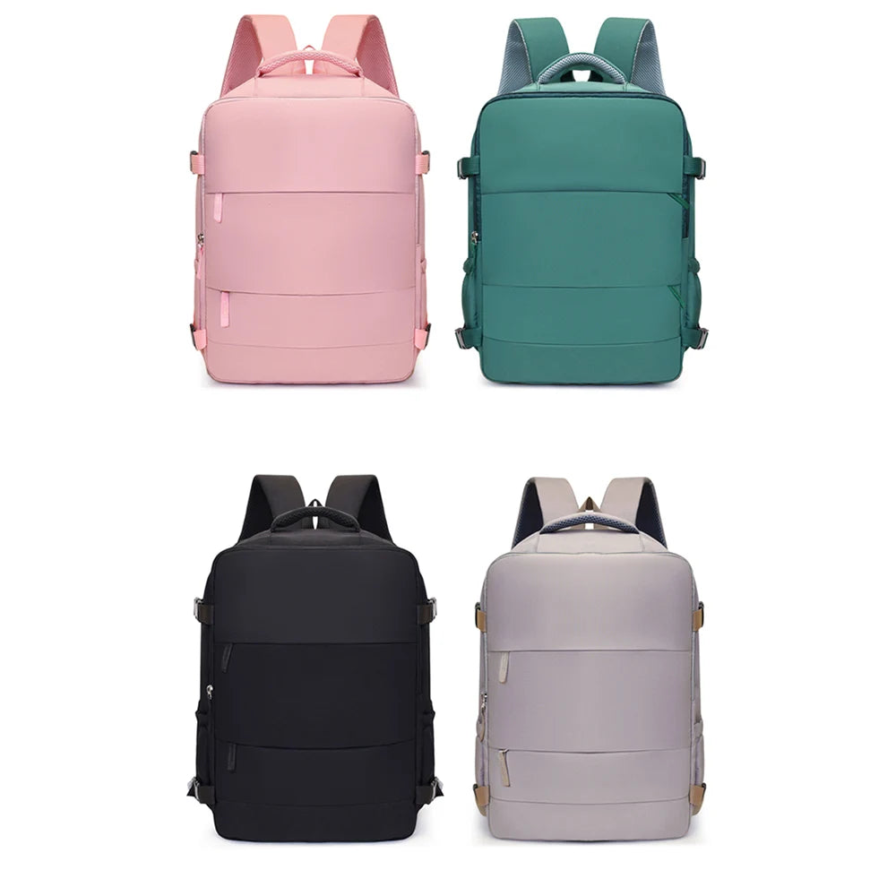 Three travel backpacks in pink, teal, and gray/black colors shown from the back.