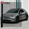 A silver Tesla Model 3 is shown with a dark tint applied to the windows, parked outdoors.