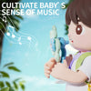 A child holds a blue suction cup spinning toy shaped like an animal, set against a bright outdoor background with musical not