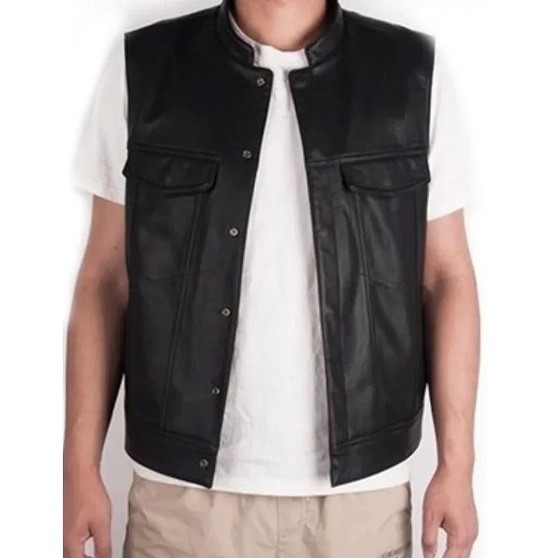 A man wearing a black faux leather biker vest over a white shirt.
