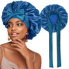 A woman wearing a blue satin sleeping bonnet with an adjustable tie and purple earrings.