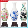 A white ceramic vase with blue floral patterns and a panda design, shown with its matching dark wooden puzzle base.