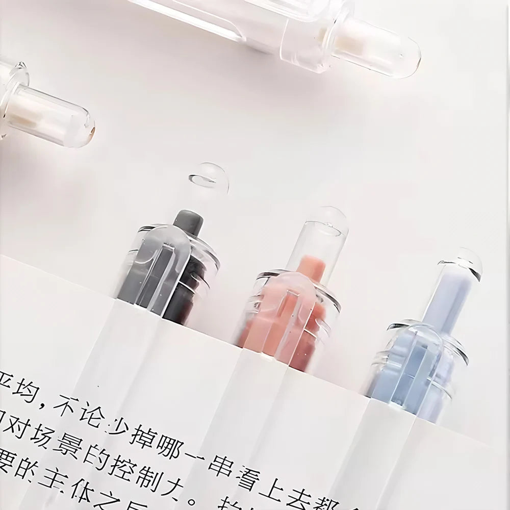 A close-up view of five retractable gel pens with clear plastic bodies and various colored ink cartridges on a white backgrou