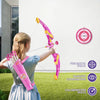A girl is practicing archery with a pink and yellow bow and arrow set outdoors on a green lawn.