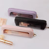 Three clear waterproof travel makeup organizer pouches in lavender, black, and pink with leather trim.