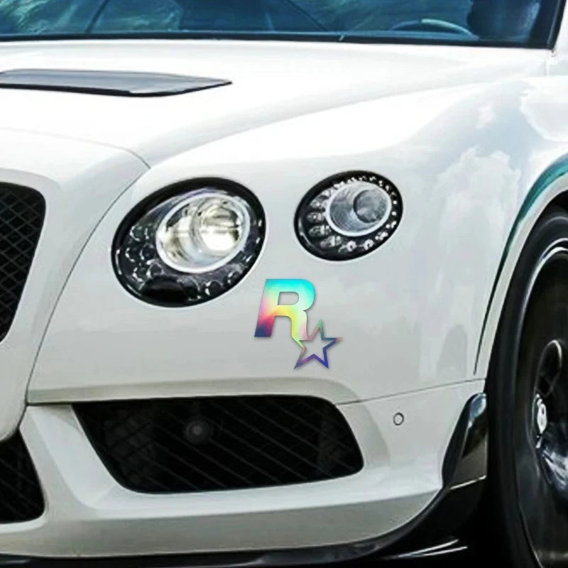 Close-up of a white car's front grille and headlights featuring an R-Star reflective decal.