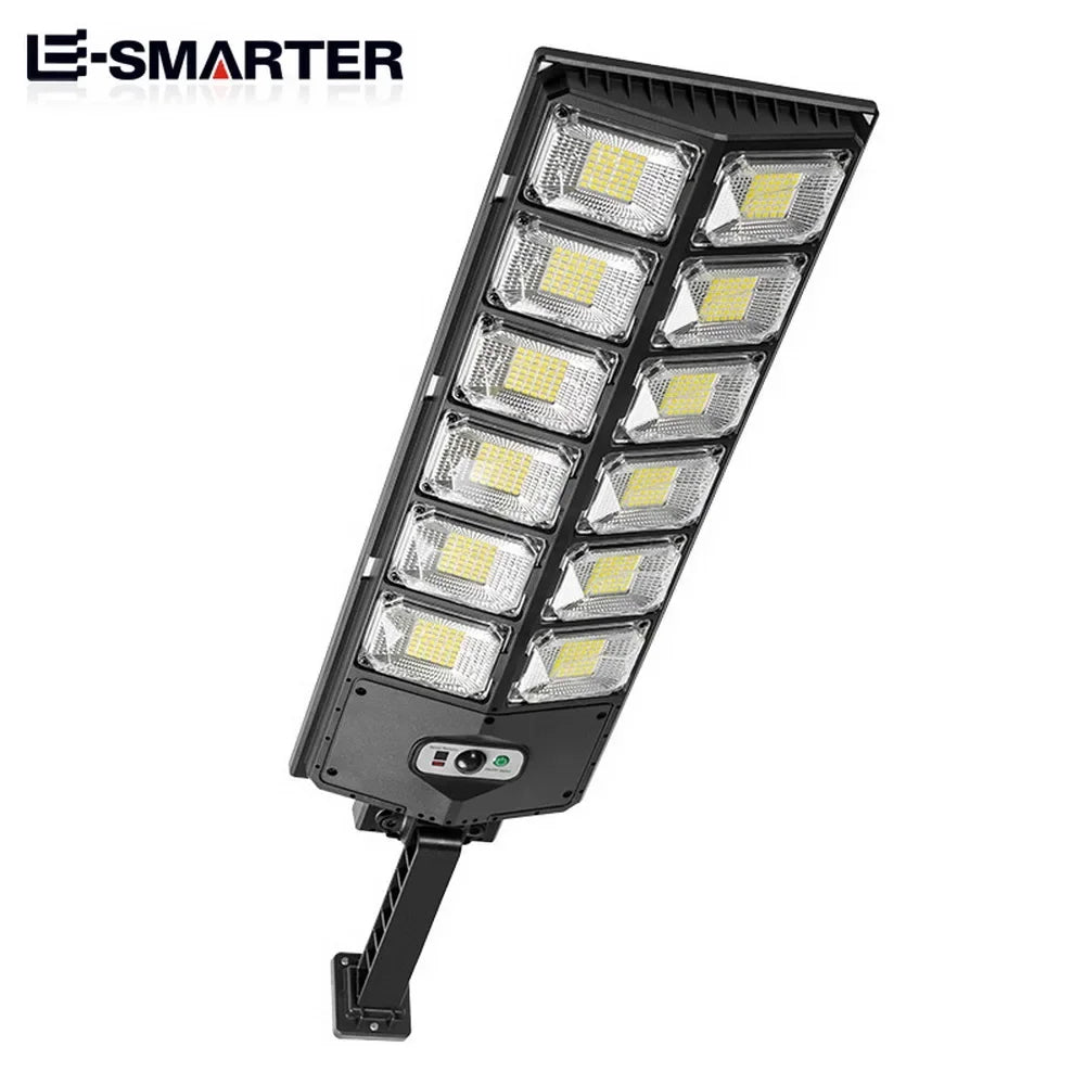 A black motion-activated solar garden light with multiple LED panels.
