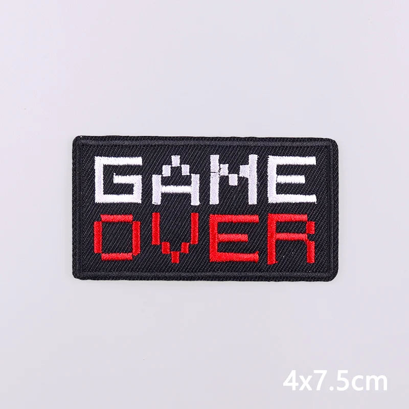 Black embroidered patch with the text GAME OVER in white and red lettering