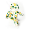 A white and yellow patterned outfit for a baby doll, including a matching hat and jumpsuit.