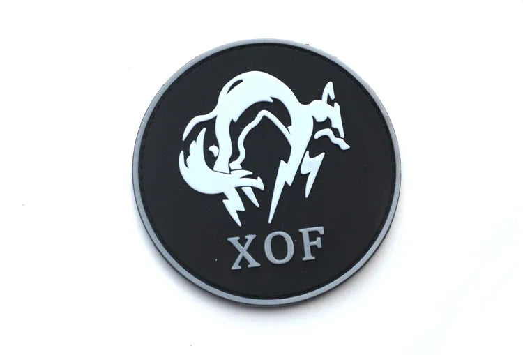 Black embroidered patch featuring a white fox silhouette with a hook and loop backing, labeled XOF.