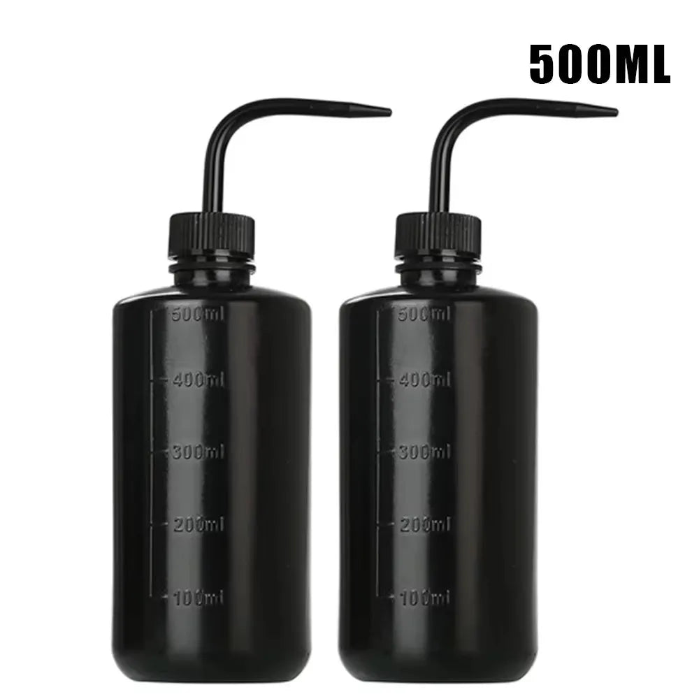 Two black tattoo squeeze bottles with precision tips and volume markings