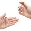 A hand holds a small glass bottle with a cork stopper, demonstrating the product for DIY crafts.