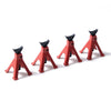 A set of red RC car decorative accessories including a surfboard, kayak, and roadblock.