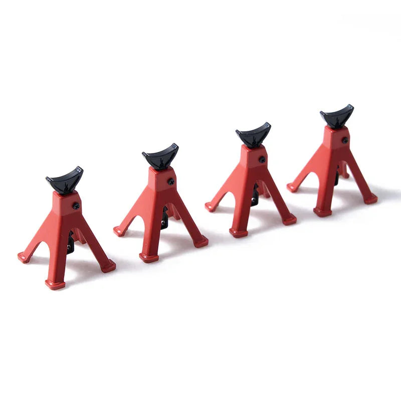 A set of red RC car decorative accessories including a surfboard, kayak, and roadblock.