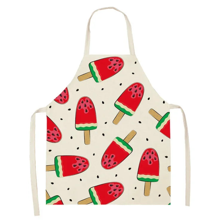 A white linen kitchen apron featuring a repeating pattern of sliced watermelon fruit illustrations.