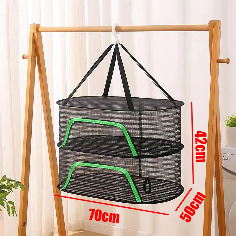 A folding wooden rack displaying a black mesh hanging drying net with two tiers and green accents.