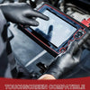 A hand wearing a black glove touches a digital device with a finger in a close-up shot.