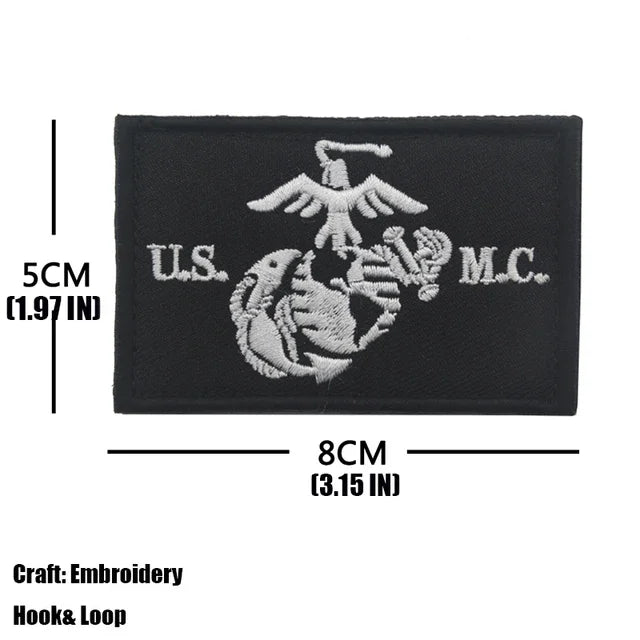 Black embroidered tactical patch featuring an eagle and a marine silhouette with U.S. and M.C. text.