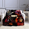 A black and red printed flannel throw blanket featuring imagery of the Kiss band members.