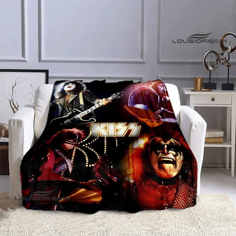 A black and red printed flannel throw blanket featuring imagery of the Kiss band members.