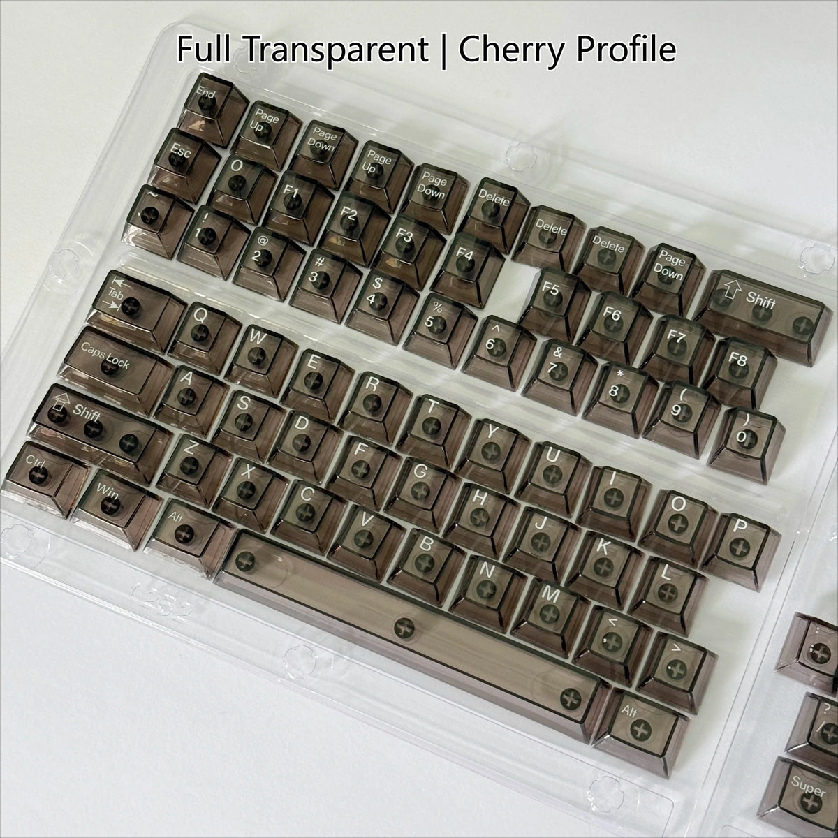 A transparent acrylic case holding a full set of cherry profile mechanical keycaps for a keyboard