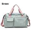 A light mint green waterproof travel duffle bag with pink straps and a shoe compartment.