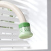 A light green kitchen faucet sprayer with a white flexible hose is shown against a white background.