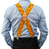 A man wearing a light blue shirt and black pants with orange elastic X-back suspenders.