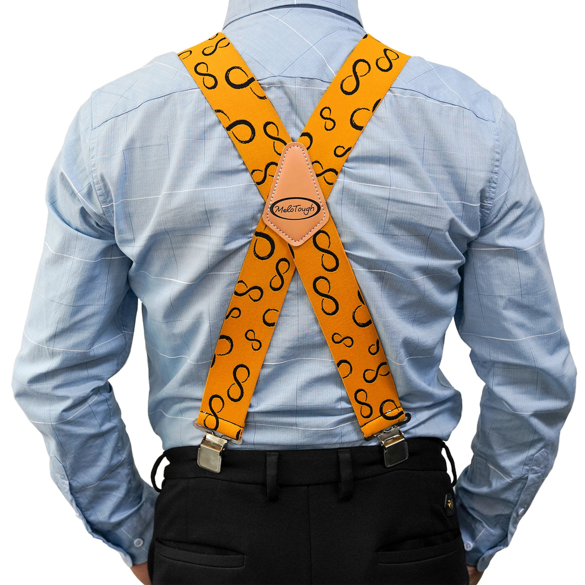 A man wearing a light blue shirt and black pants with orange elastic X-back suspenders.