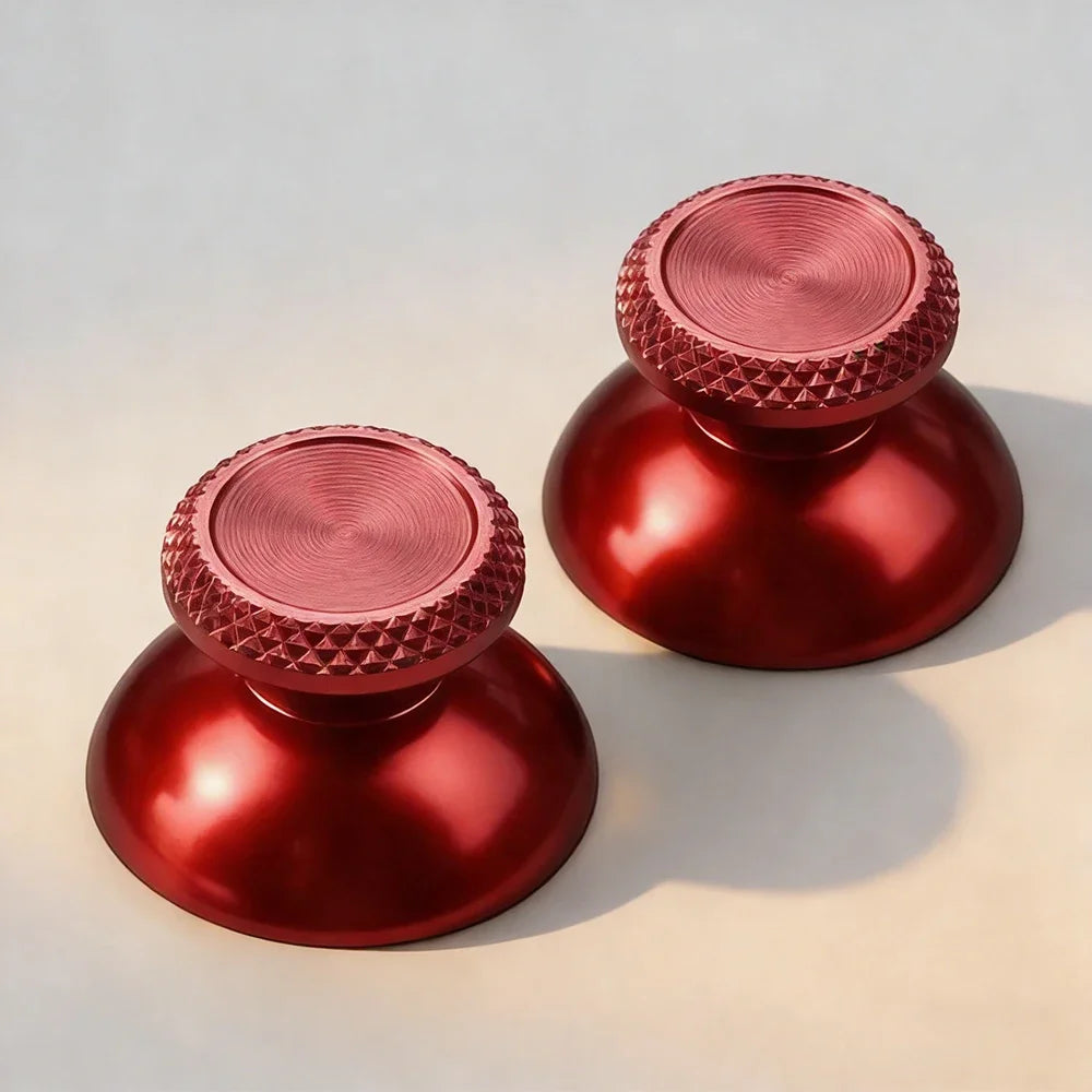 Two metallic red aluminum thumbstick grips for a PS5 controller, shown from above.
