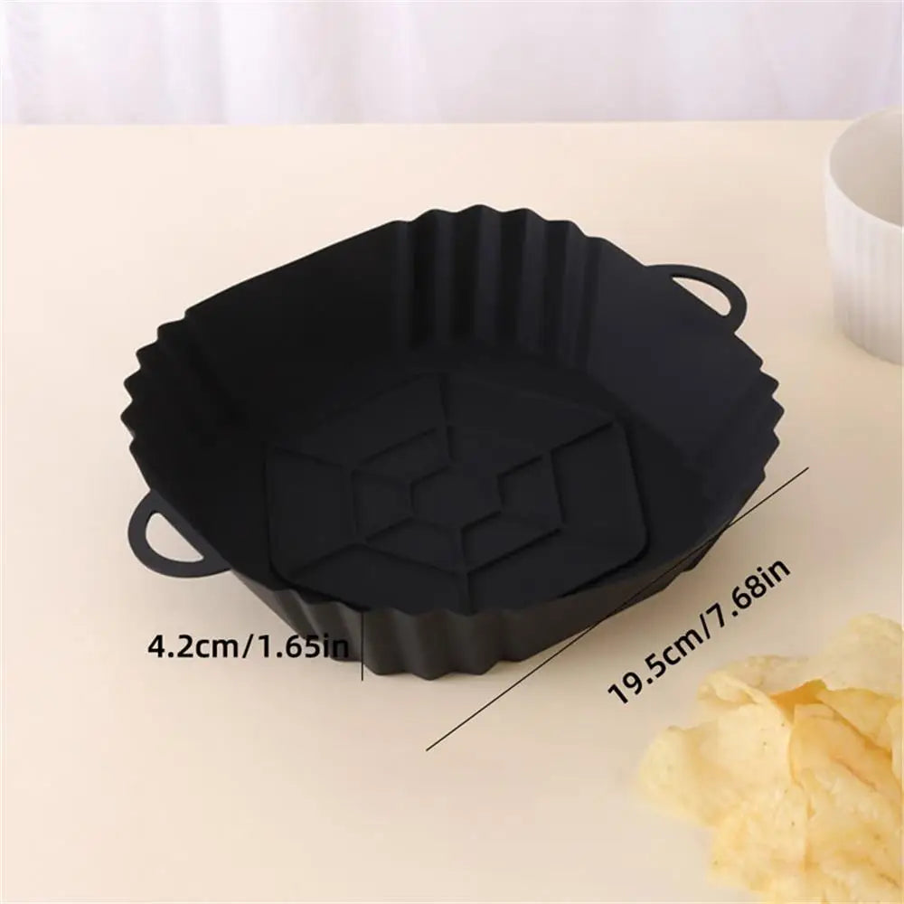 Black reusable square air fryer silicone liner with a ribbed edge and handle.
