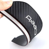 A matte black carbon fiber rearview mirror rain guard with a white trim is shown from the side.