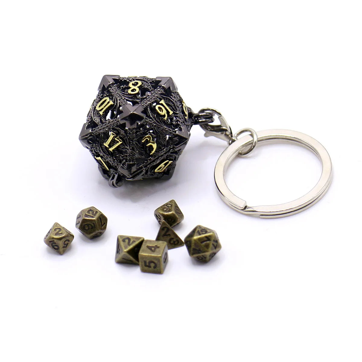 A black metal die with gold numbers is attached to a silver ring, alongside several loose dice.