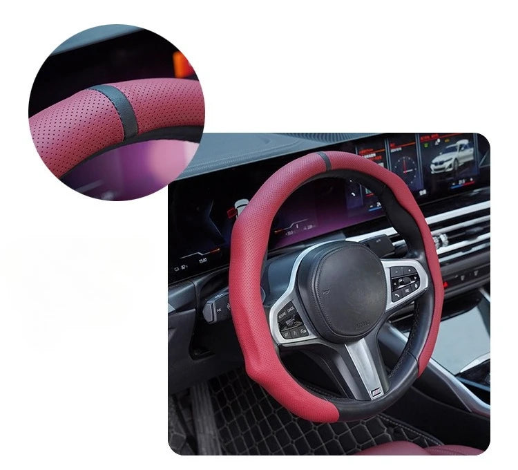 Close-up view of a pink perforated leather steering wheel cover on a car's steering wheel.