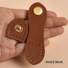 A set of eight brown leather buckle clasps with gold accents shown in a person's hand.