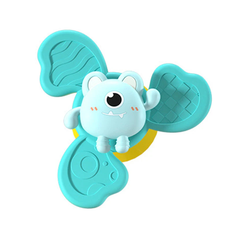 A light blue suction cup spinner bath toy shaped like an elephant for toddlers.