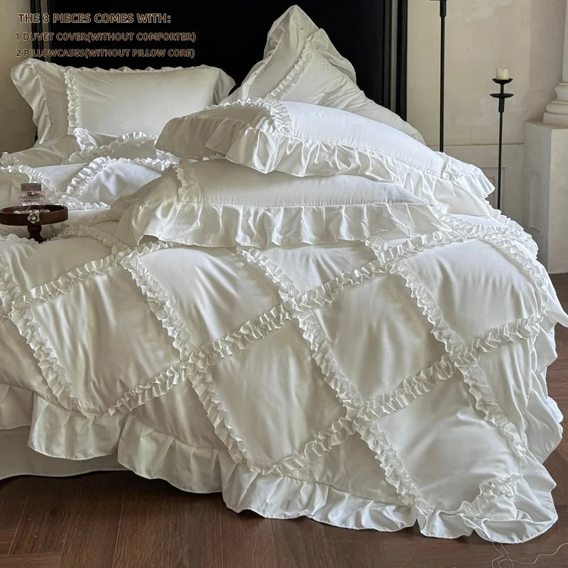 A white ruffled duvet cover set with matching pillowcases displayed on a bed.