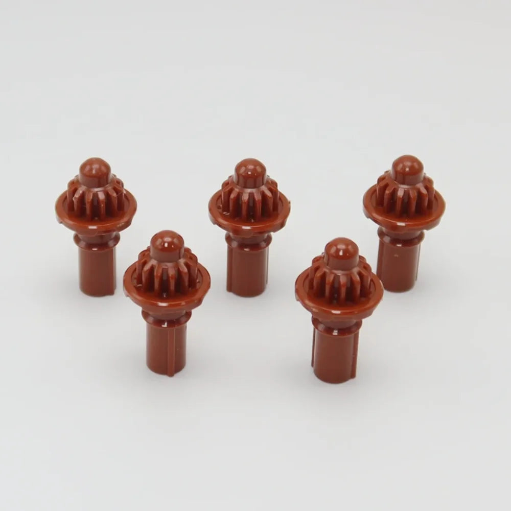 A set of five brown replacement drivers for a Takara Tomy Battling Top, displayed against a light gray background.