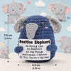 A blue elephant crochet plush toy with large ears and a tag that reads Positive Elephant