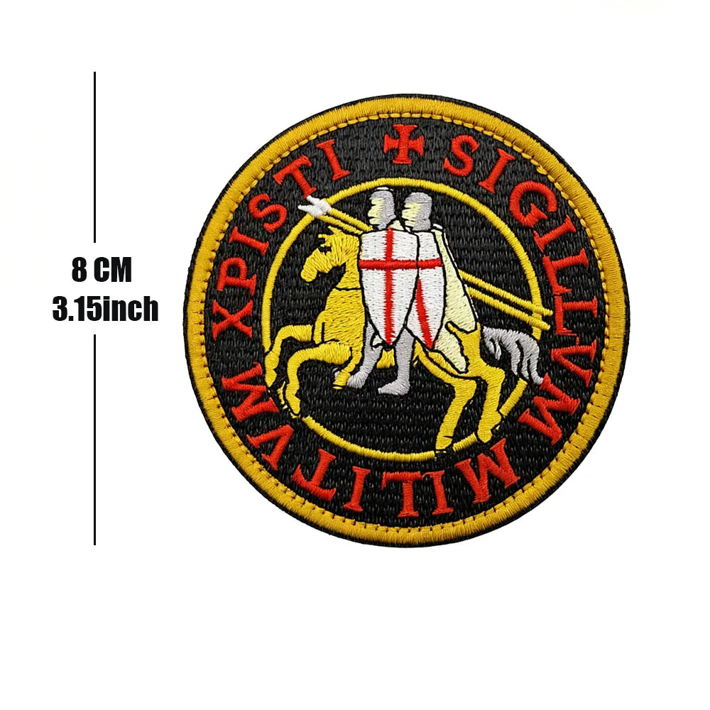 Embroidered patch featuring a golden lion, two knights, and Latin text on a black circular background.