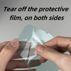 Hands tear off a protective film from an anti-fog lens on motocross goggles.
