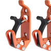 A pair of heavy-duty orange wall mount tool holders designed for securing shovels, axes, and other tools.