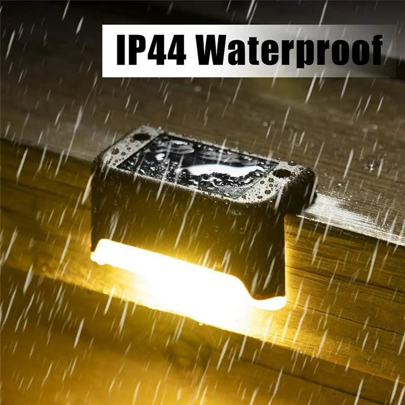 A solar deck light illuminates a wooden surface, demonstrating its IP44 waterproof feature.