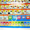 A colorful interactive learning poster featuring letters, numbers, and words for Spanish and English.