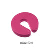 A solid pink foam door stopper with a finger pinch protection design.