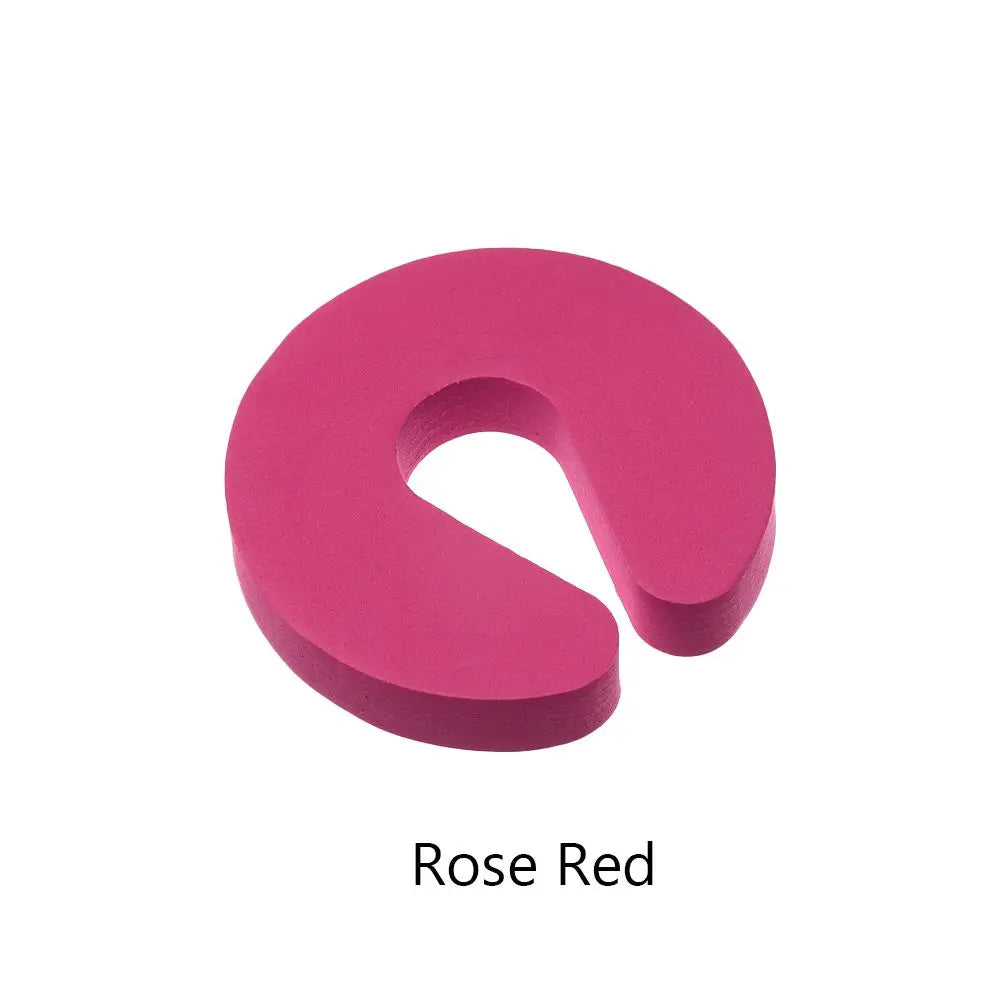 A solid pink foam door stopper with a finger pinch protection design.